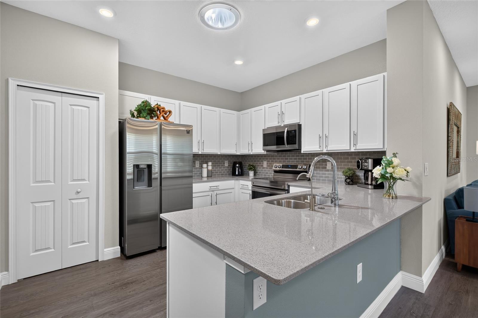 Kitchen with white shaker cabinets, tile backsplash, stainless steel appliances. Kitchen with white shaker cabinets, tile backsplash, stainless steel appliances.