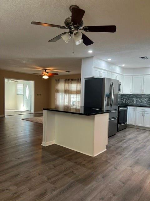 Open concept with views of Kitchen, Living area, Florida Room and entryway.