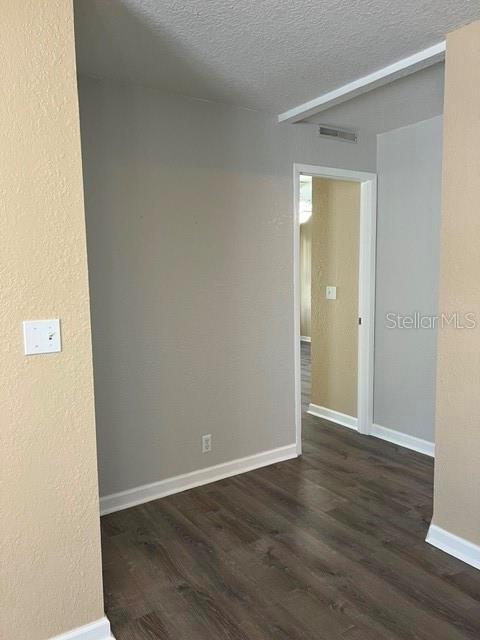 View from dining room area to bedrooms and baths