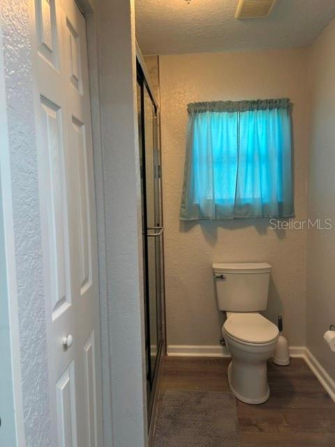 Water Closet area with Glass in Shower and Linen Closet on Left