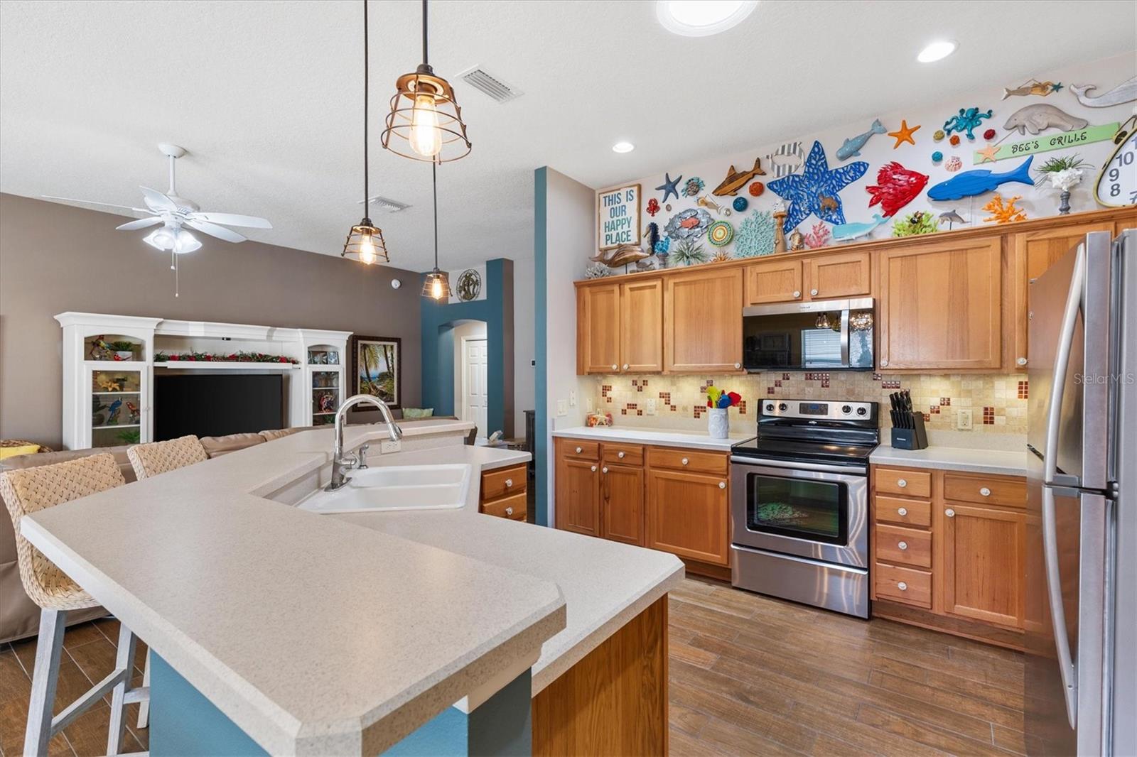 KITCHEN WITH LOTS OF CABINETS AND BAR STOOLS
