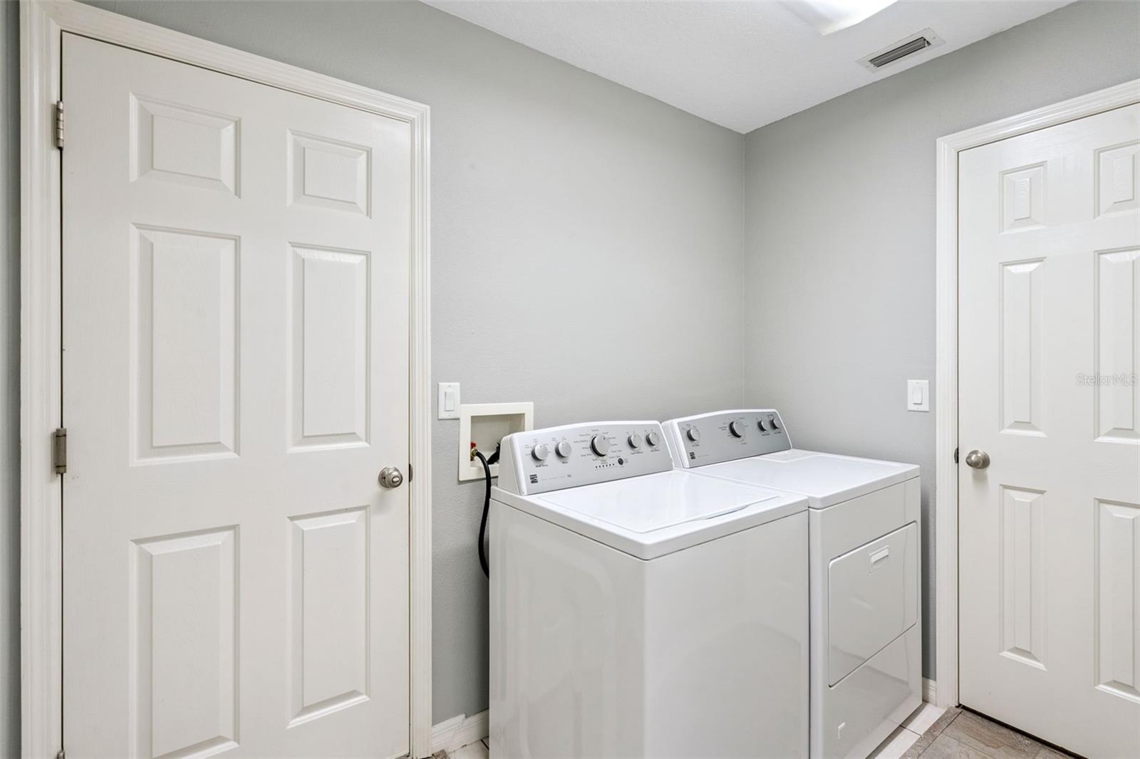 Inside laundry room has additional storage pantry.