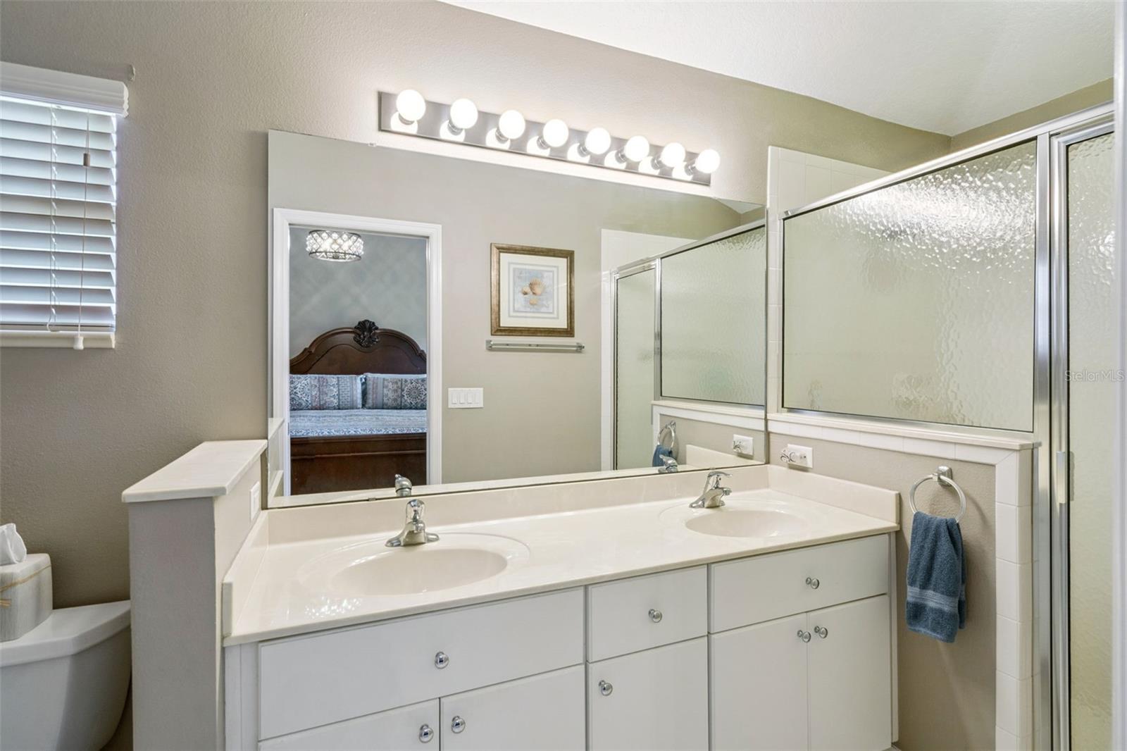 Primary bath with dual sinks and walk-in shower.