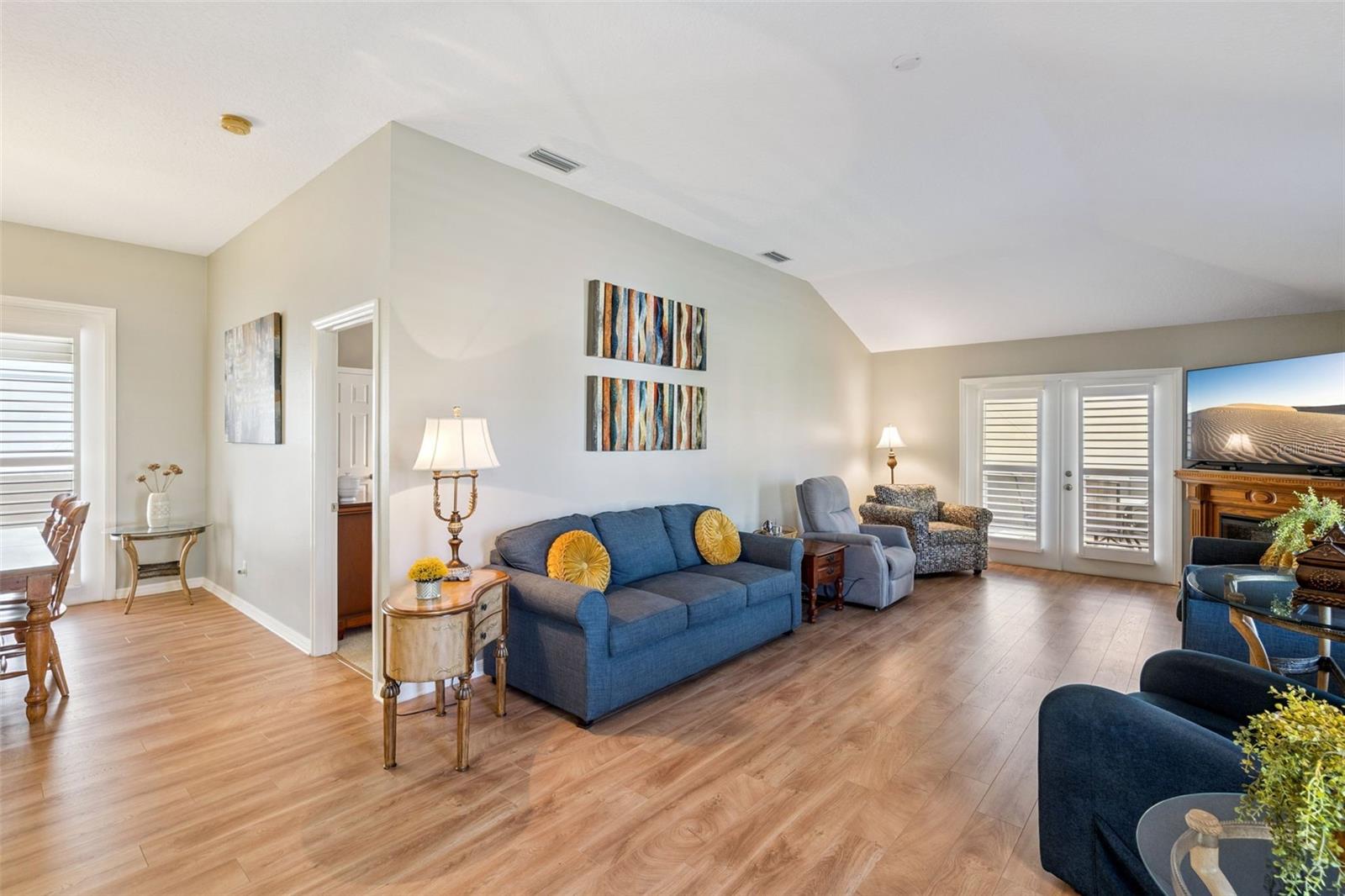 Vaulted Living Room with French doors to the larger screened lanai. Vaulted Living Room with French doors to the larger screened lanai.