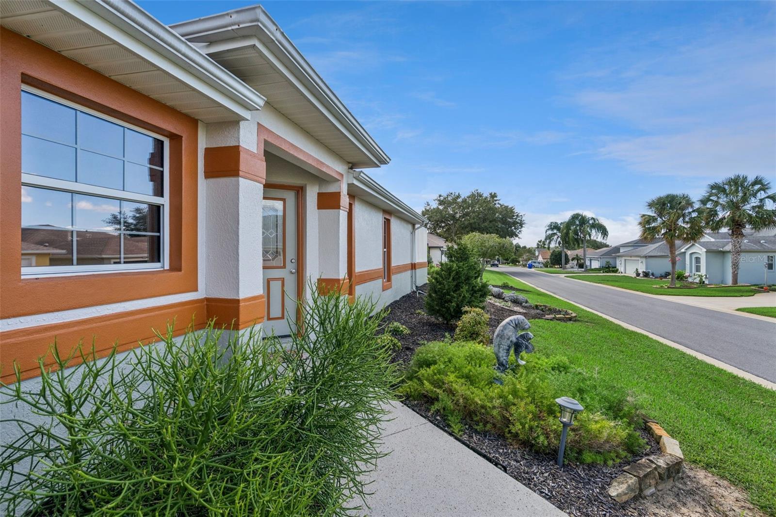 Landscaped beds frame the front entry.