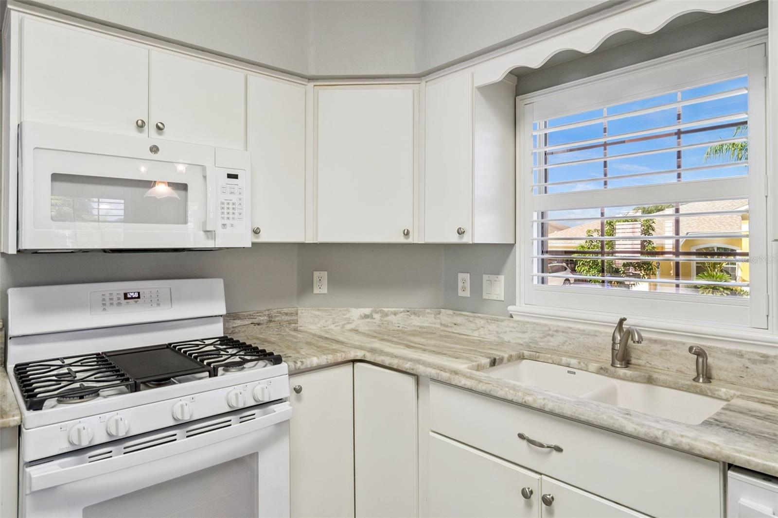 Granite counters and a window over the sink.