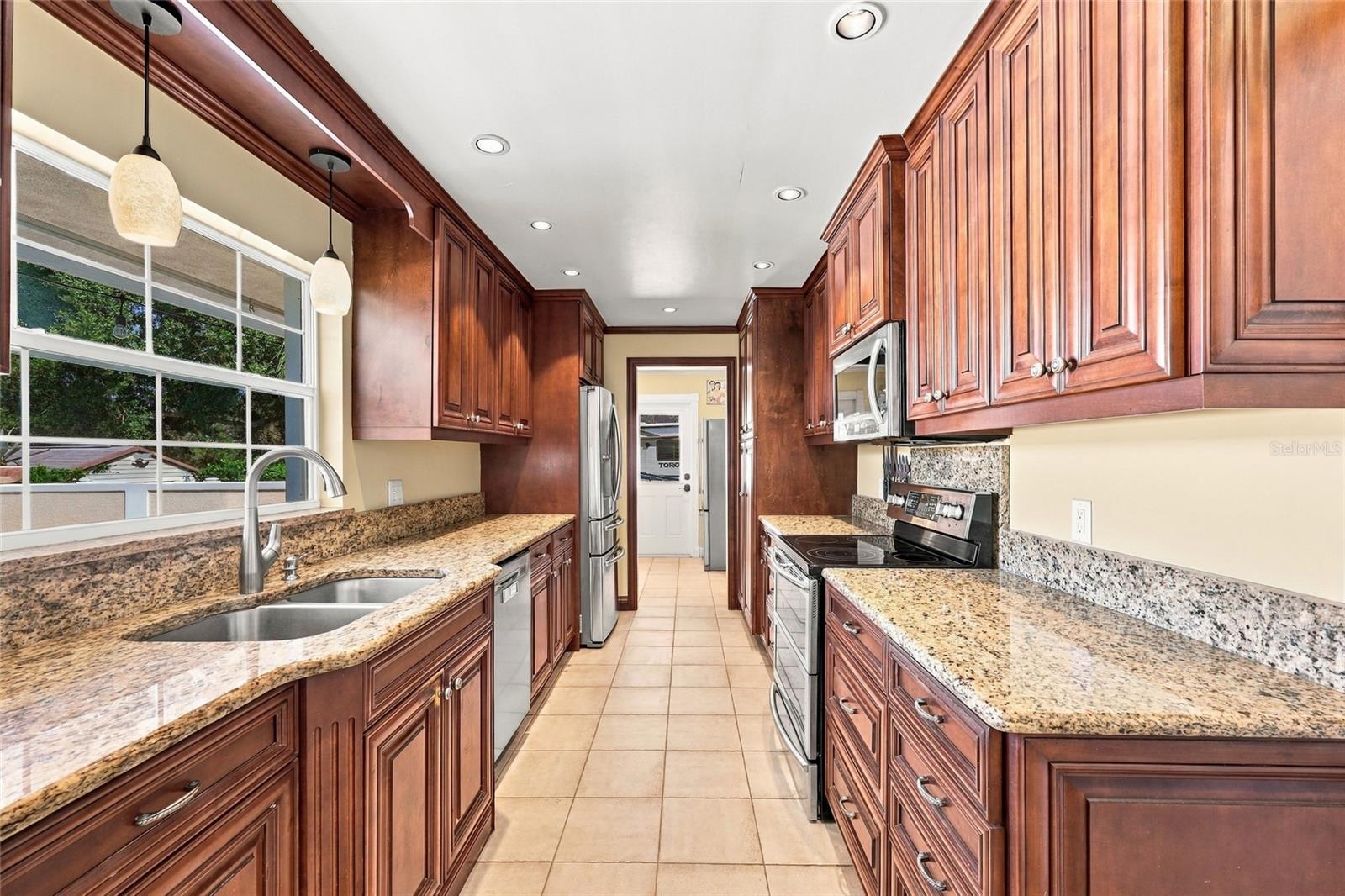 Kitchen with granite counters & view of pool