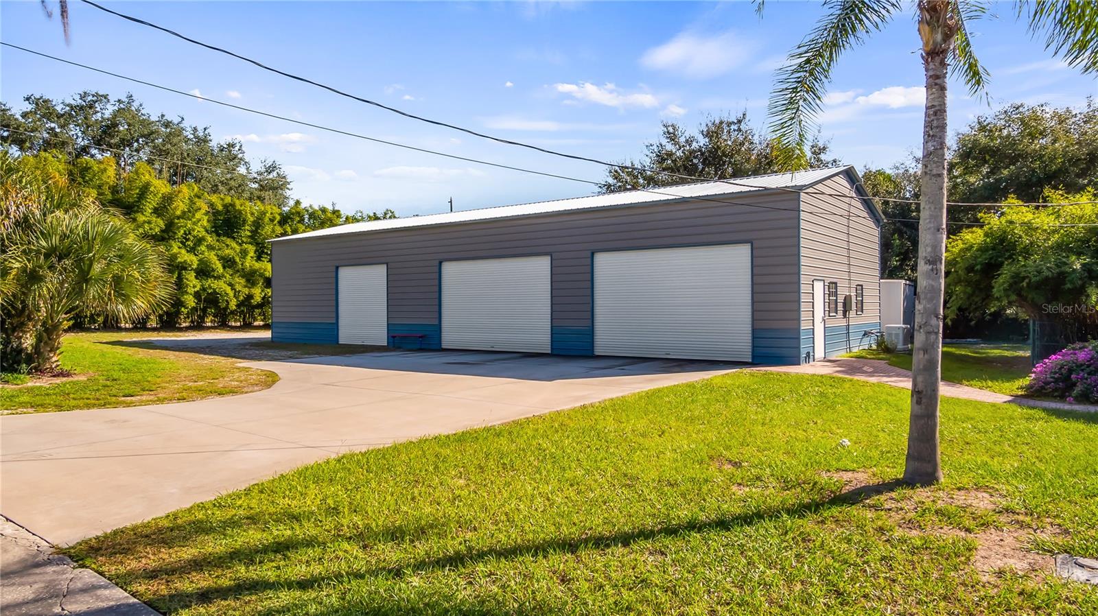 HUGE 30X75 Metal Building installed in October of 2022, has 6 large bay doors, some have electric openers. The completely paid off solar panels are located on top of this metal building. It basically covers the power bill for the main pool home and this building. The whole home generator is located on the south side of this metal building. It helps to support the main home and this building when Power is out.