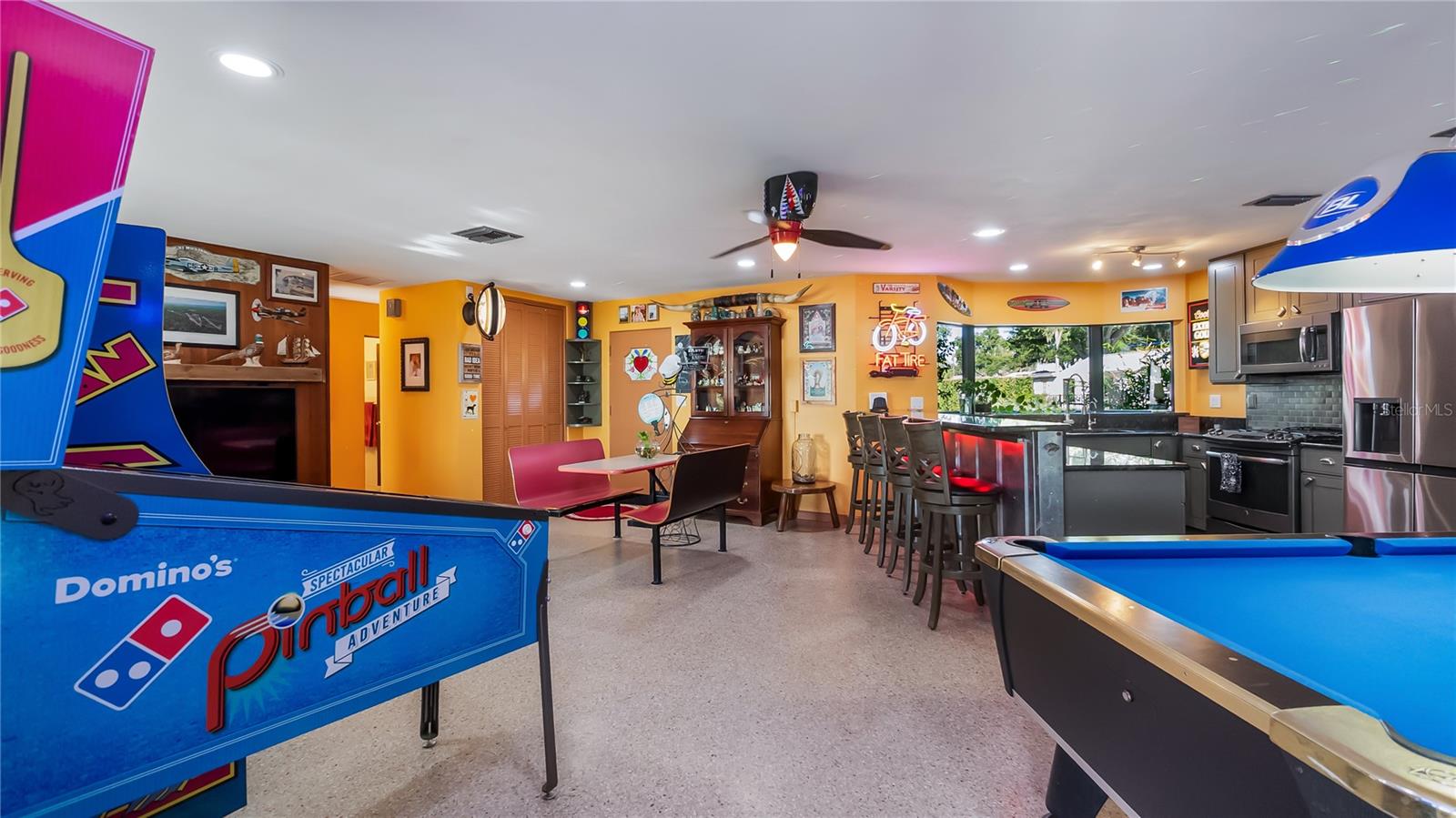 Main Home - Great room/kitchen/living room combo: Living room used as gathering space for game room fun. Two Sliders go out to covered back porch and screened in pool