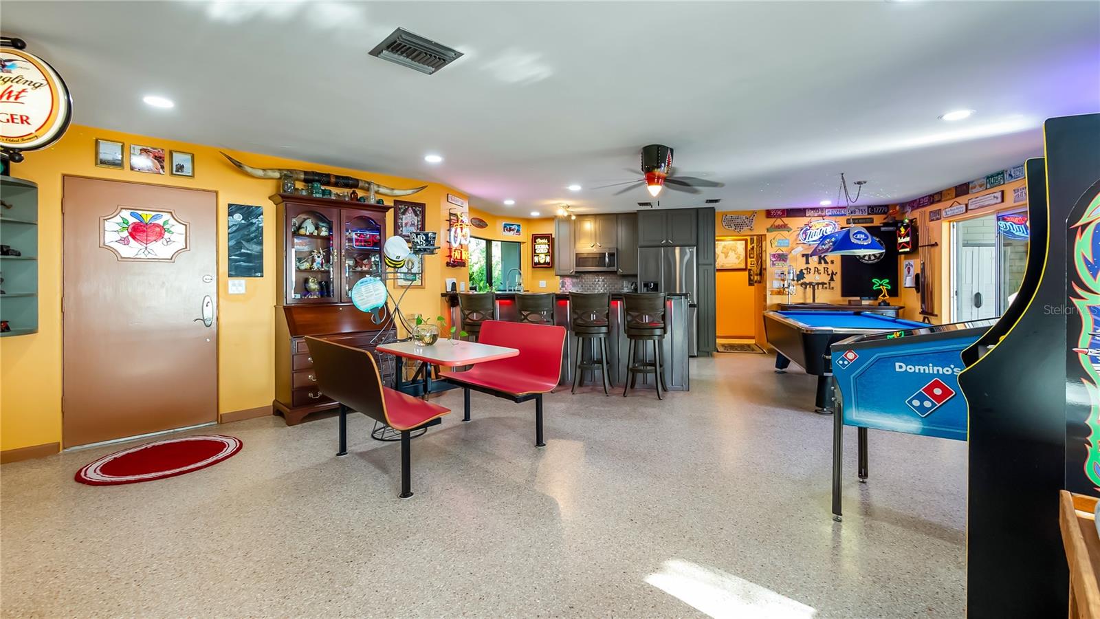 Main Home - Great room/kitchen/living room combo: Living room used as gathering space for game room fun. Two Sliders go out to covered back porch and screened in pool