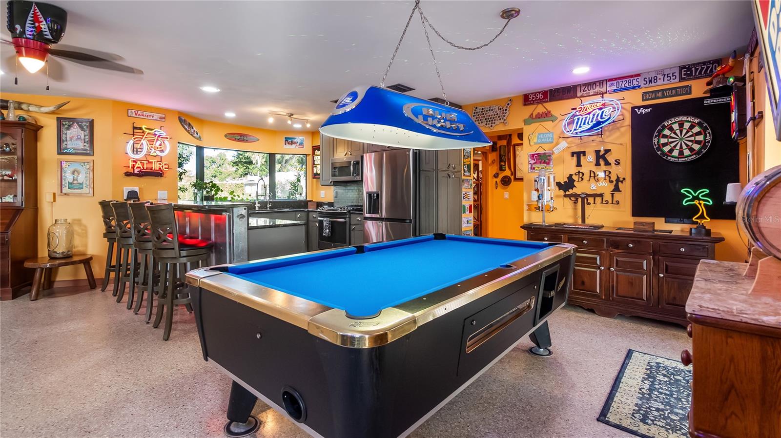 Main Home - Great room/kitchen/living room combo: Living room used as gathering space for game room fun. Two Sliders go out to covered back porch and screened in pool