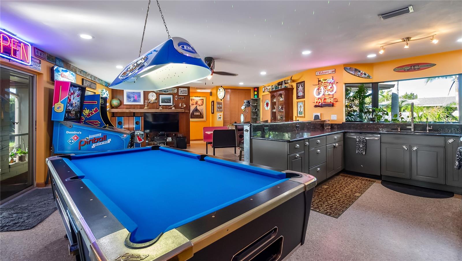 Main Home - Great room/kitchen/living room combo: Living room used as gathering space for game room fun. Two Sliders go out to covered back porch and screened in pool