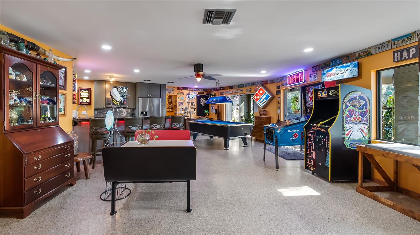 Main Home - Great room/kitchen/living room combo: Living room used as gathering space for game room fun. Two Sliders go out to covered back porch and screened in pool