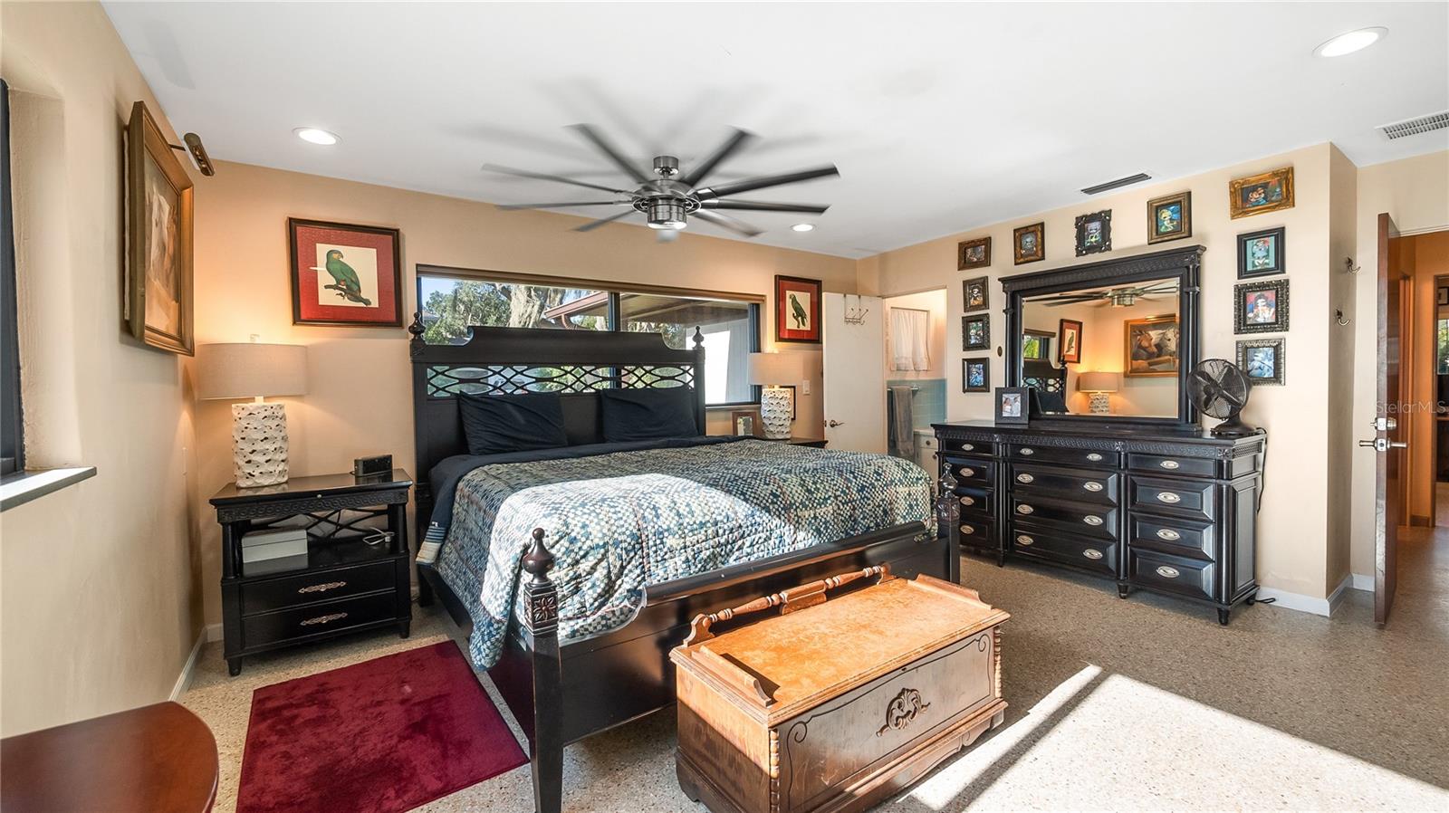 Primary with private bath and amazing lakefront views. Private exit to screened in back porch to back yard
