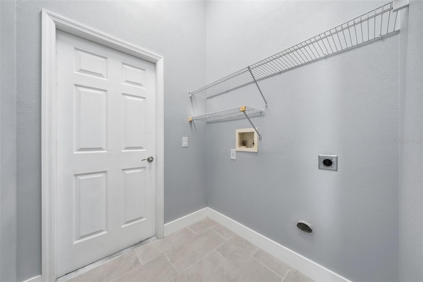 Laundry room leading to the garage