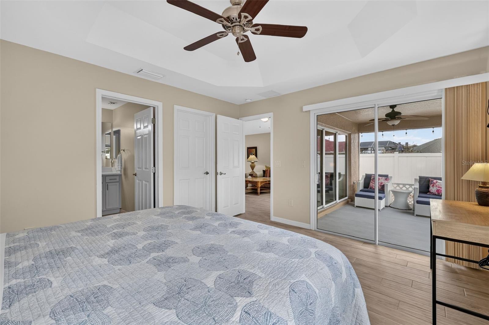 Primary Bedroom with En-Suite Bath and Sliding Doors to the Lanai
