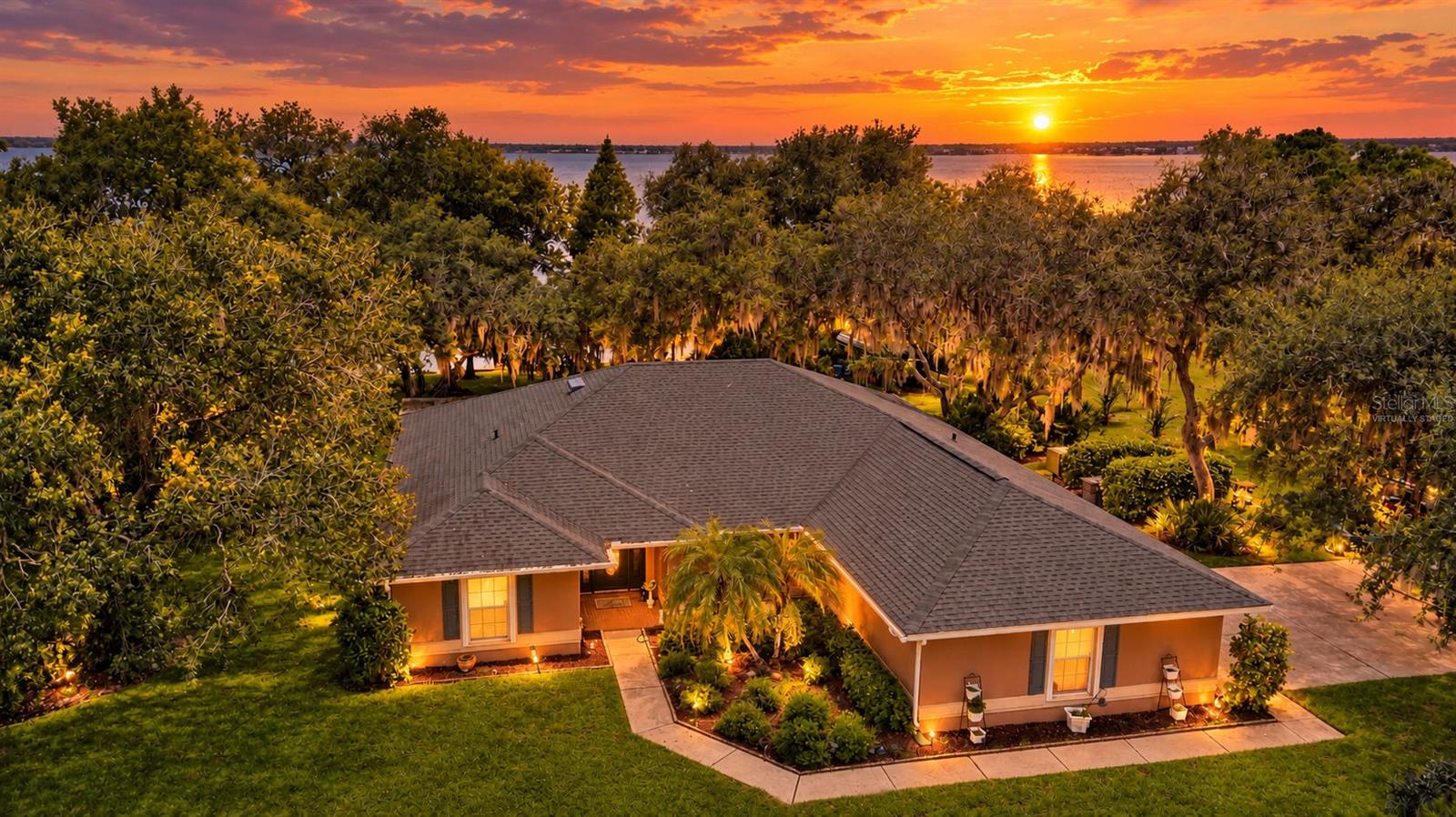 Beautiful view of the home, land, lake and sunsetVirtually staged Beautiful view of the home, land, lake and sunsetVirtually staged