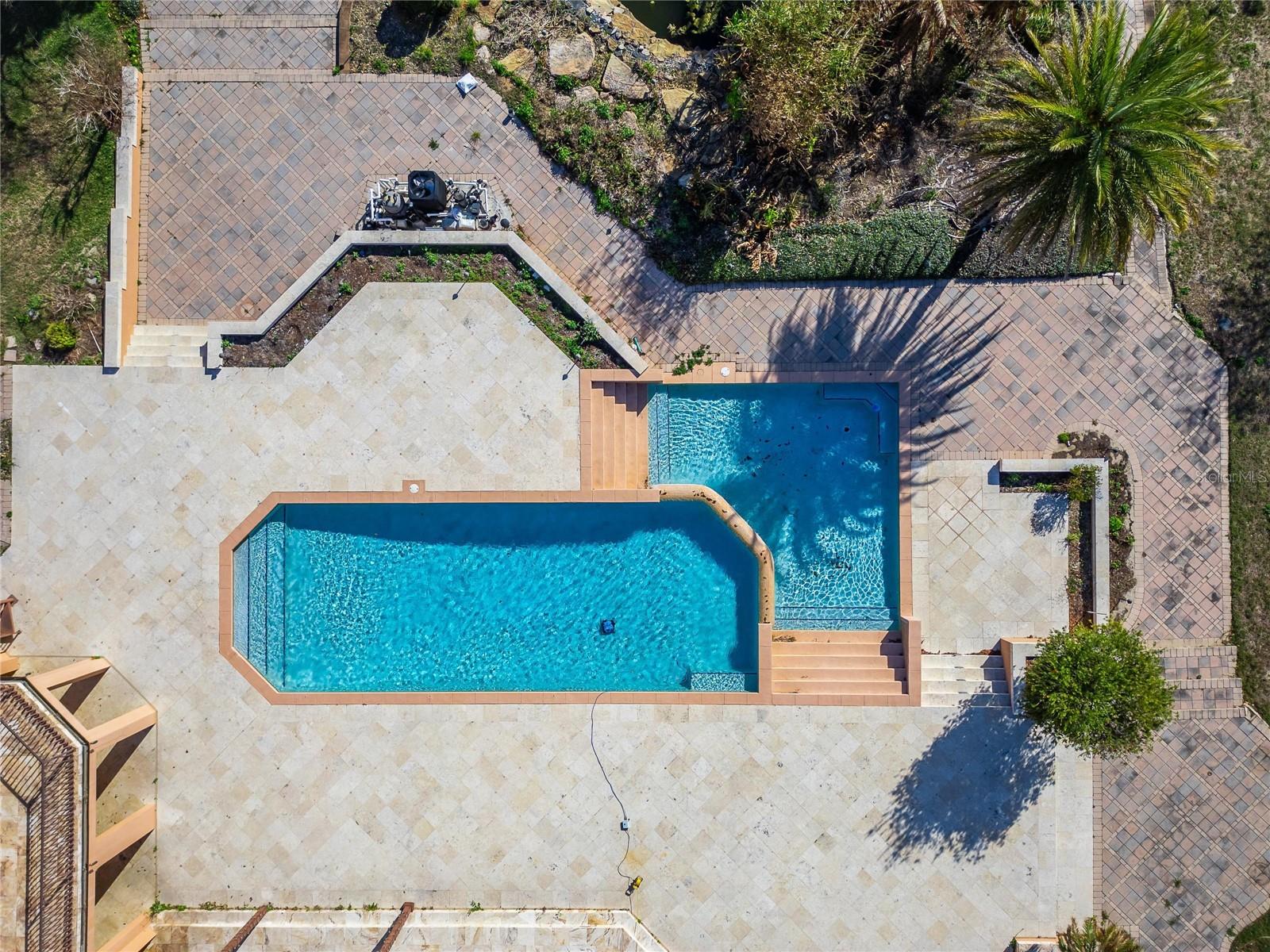 Outdoor amenities create a resort-style setting with a stunning pool featuring a waterfall edge, tennis courts, and a covered private boat dock. Additional outbuildings include a gardeners garage and pump house. Outdoor amenities create a resort-style setting with a stunning pool featuring a waterfall edge, tennis courts, and a covered private boat dock. Additional outbuildings include a gardeners garage and pump house.