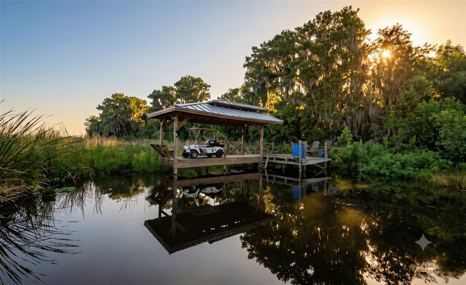 COVERED DOCK WITH MOORING LINES, SEATING AND GOLF CART PARKING