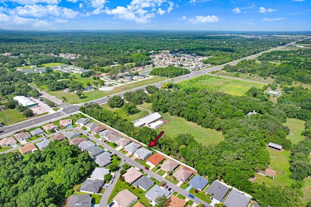 4949 Pleasant Hollow Trail with rear community fence and nearby trees providing shade and beauty.