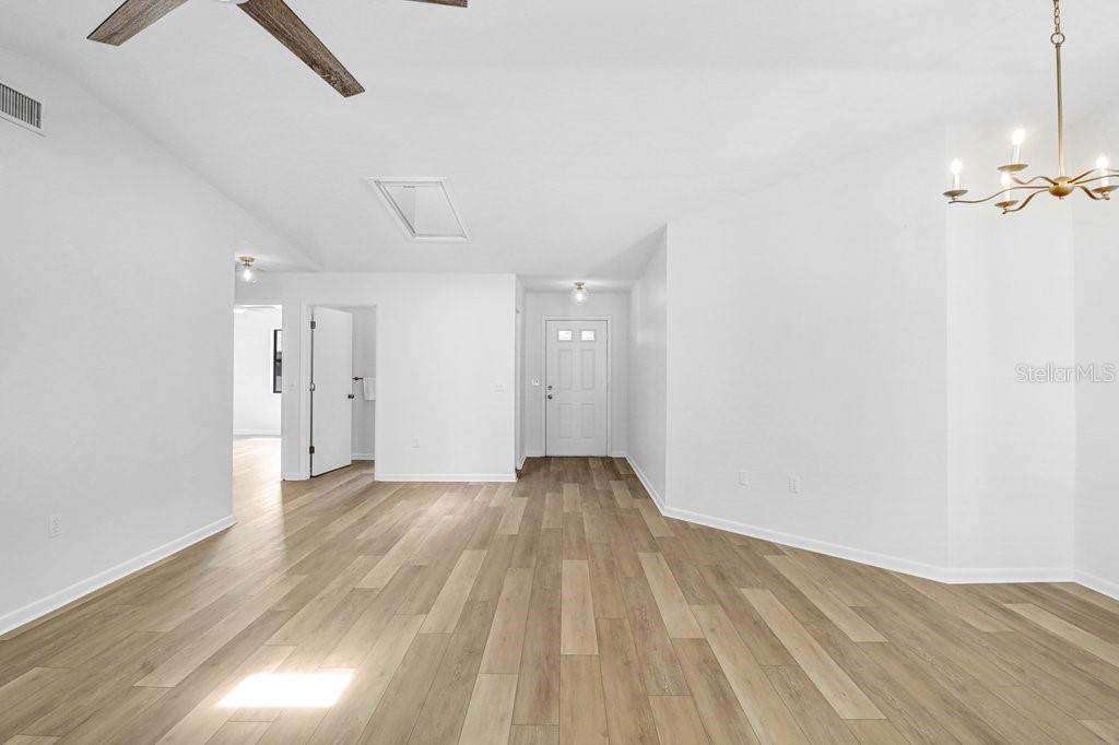 Living and Dining Room, Front Door to the right, and entrances to Hall bath and Second Bedroom.
