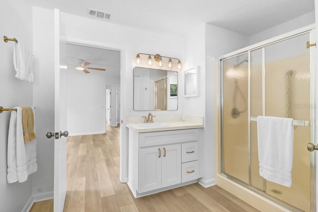 Primary Bath with separate toilet closet and large walk in closet. New vanity, door and cabinet hardware, lights and toilet. Primary Bath with separate toilet closet and large walk in closet. New vanity, door and cabinet hardware, lights and toilet.