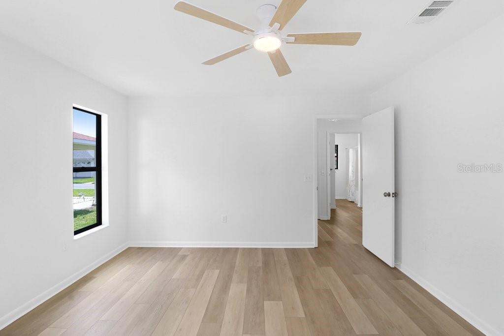 Primary Bedroom, to the rear is the ensuite . Through the door is the hall to the second bedroom and bath. To the right is the Foyer and Living/Dining Area.