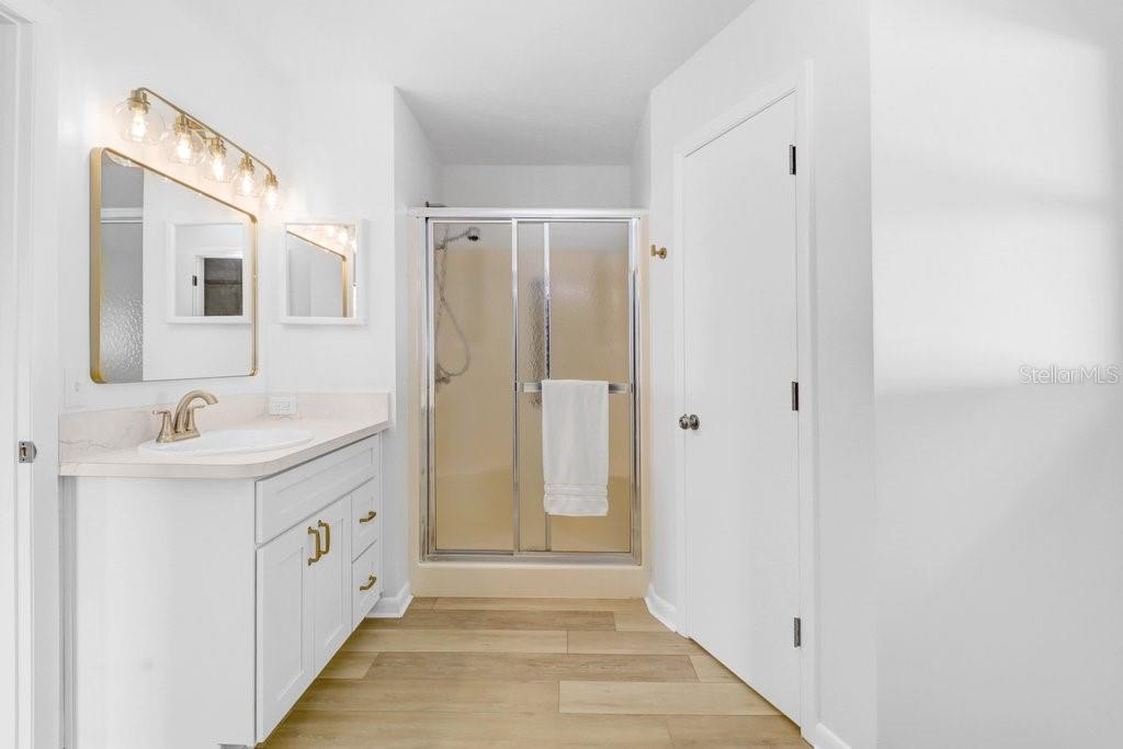 Ensuite with step in shower, new toilet with privacy to the right, walk in closet to the rear and entrance from the bedroom to the left.