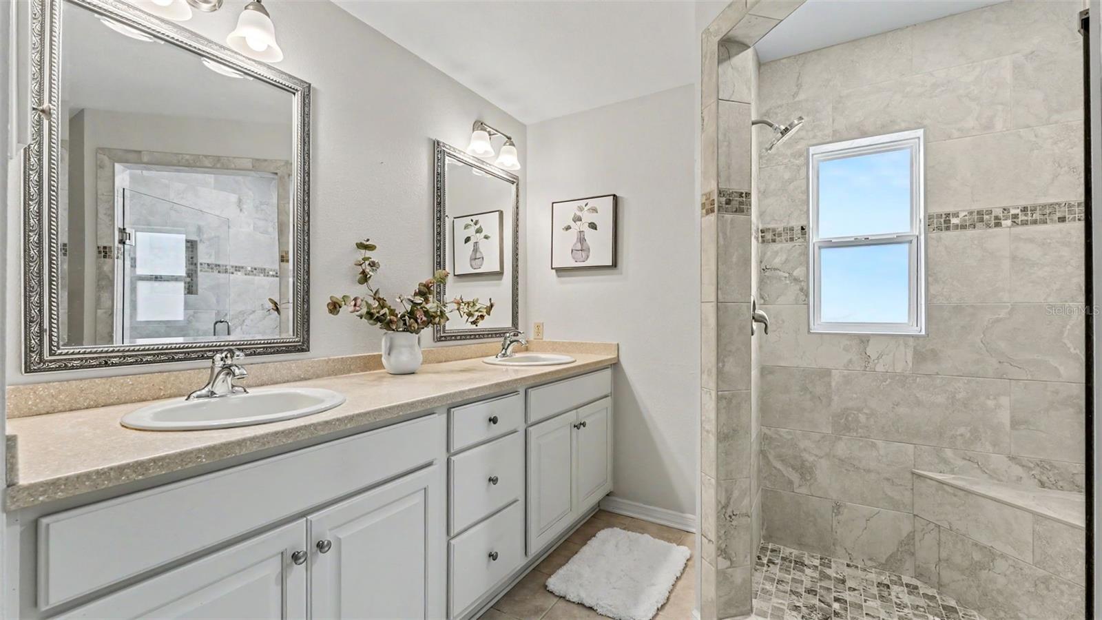 Primary suite - ensuite private bathroom with double vanities, walk-in shower, toilet room, and linen closet