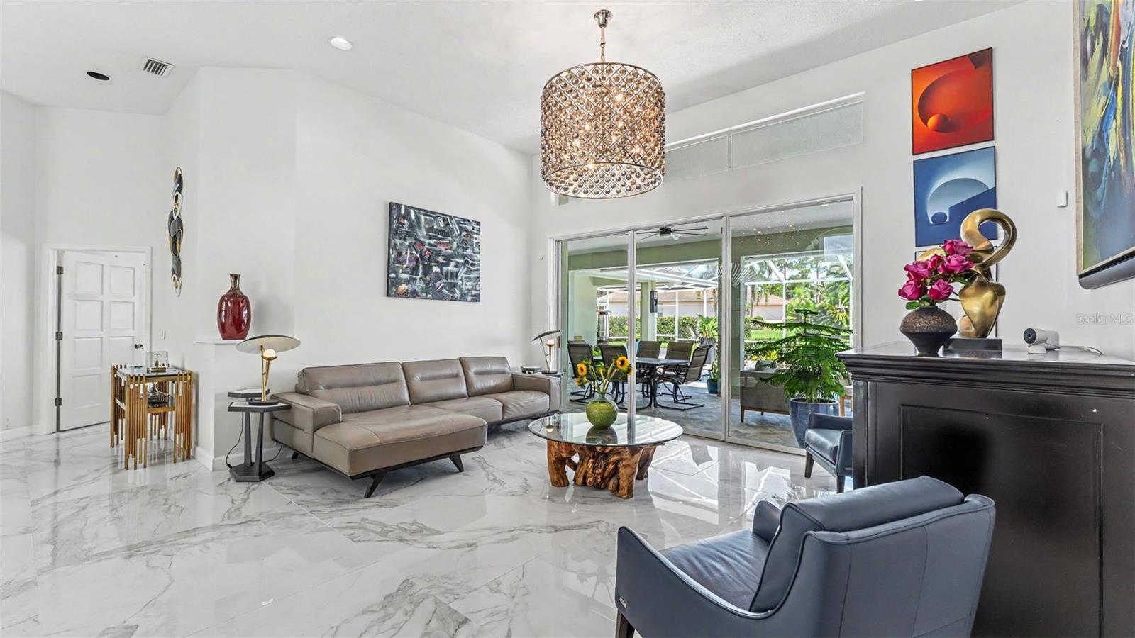 The Living Room has a nice airy feeling and features volume ceilings, tile floors, sliders leading out to the pool area