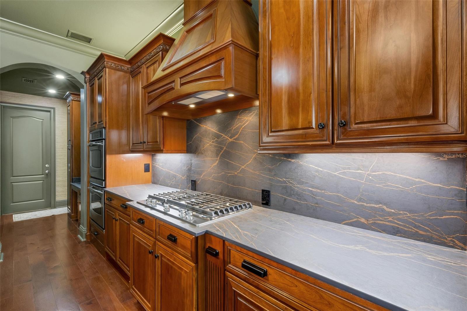 The six-burner gas cooktop, built-in ovens, built-in GE Monogram refrigerator are just icing on the cake.