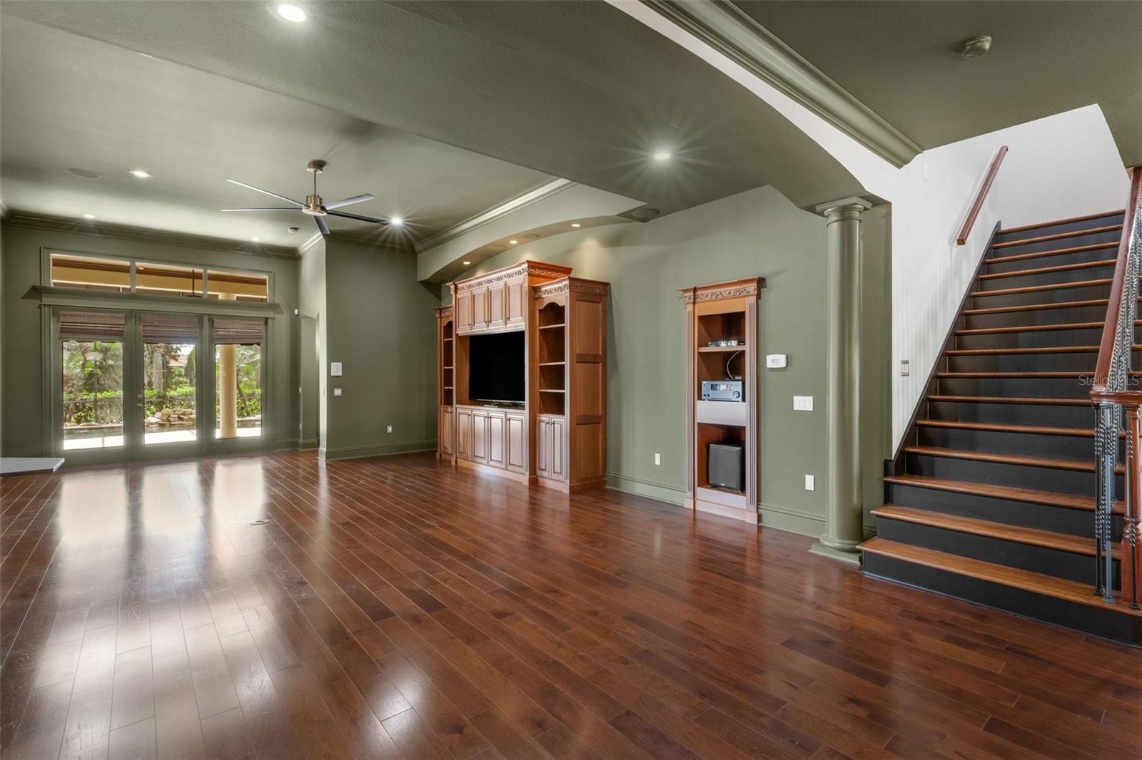 The massive greatroom features a built-in entertainment center and space for equipment elements that support the whole house sound system.