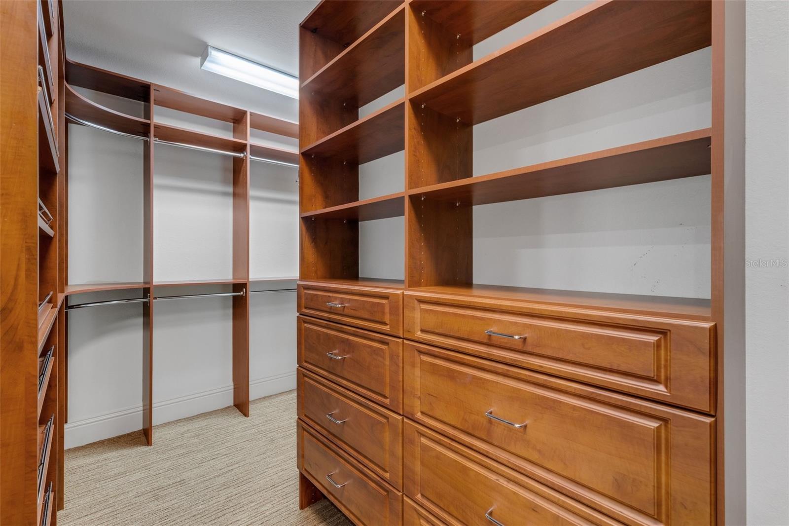 There are TWO spacious walk-in closets with custom organizer systems . . .