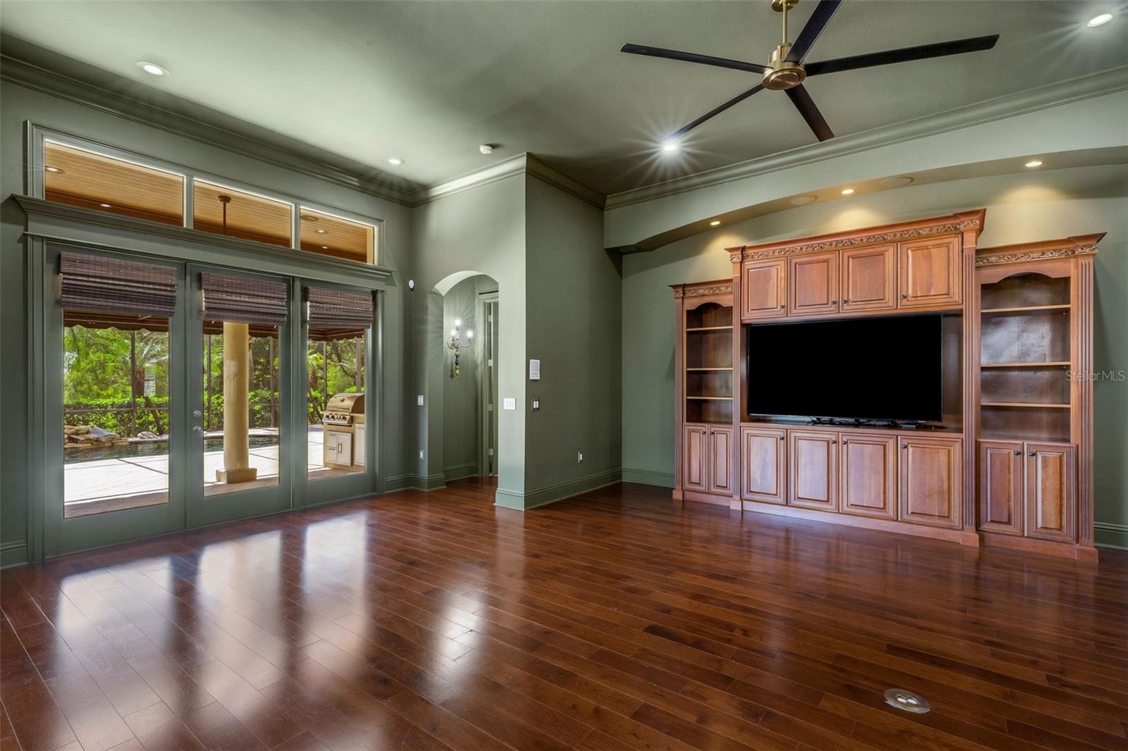 This space features a full bank of glass doors leading to the lanai and pool area.