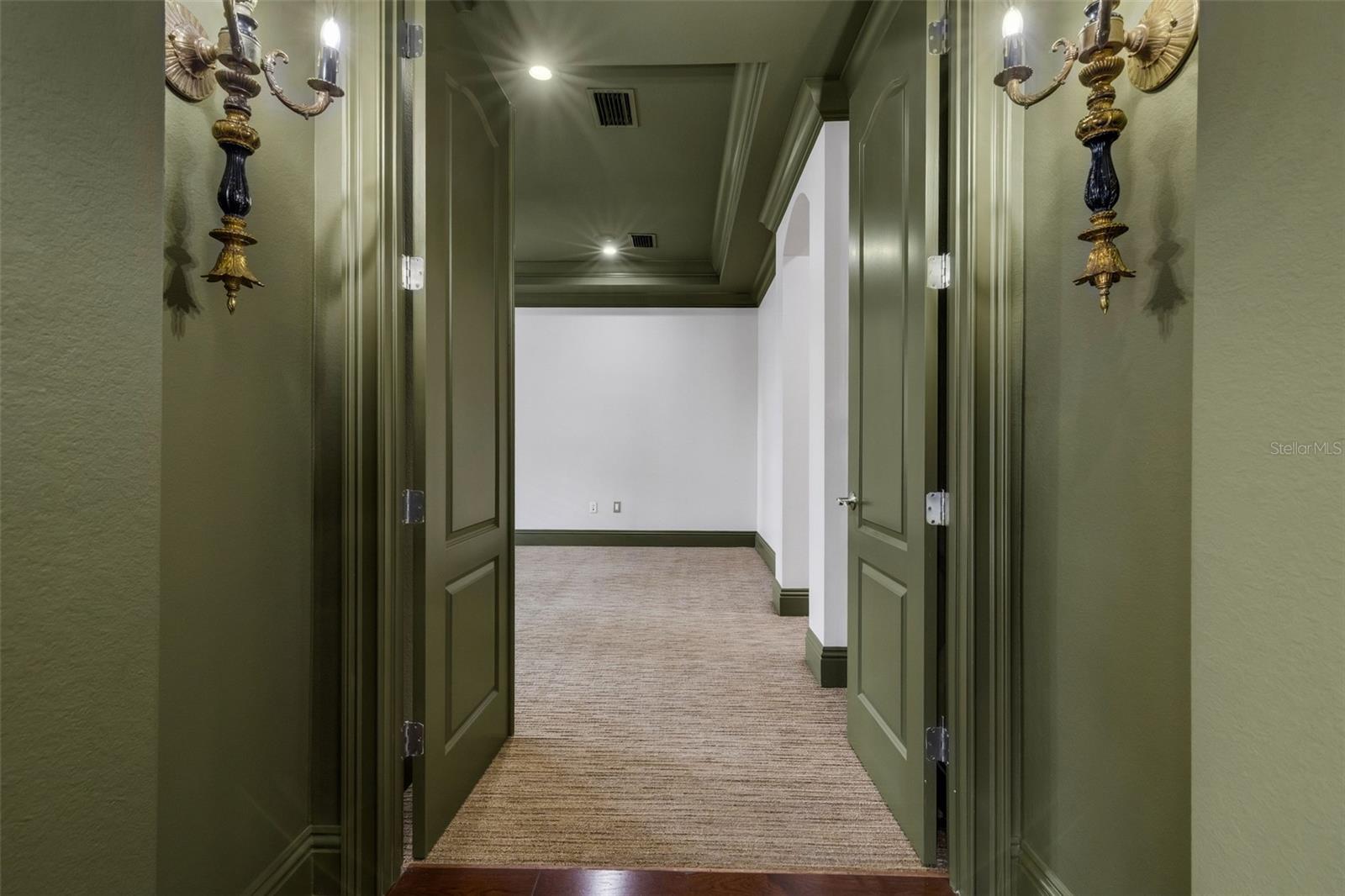 The primary suite is on the first floor and secluded away through double doors.