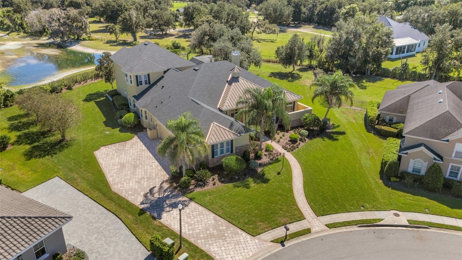 The home has a full brick paver driveway leading to a 4-car (YES, 4-CAR) garage, sidewalks and so much more.
