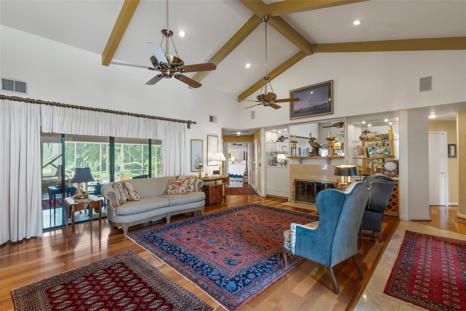 The formal living room greets all who enter with stunning views through the glass sliders . . .