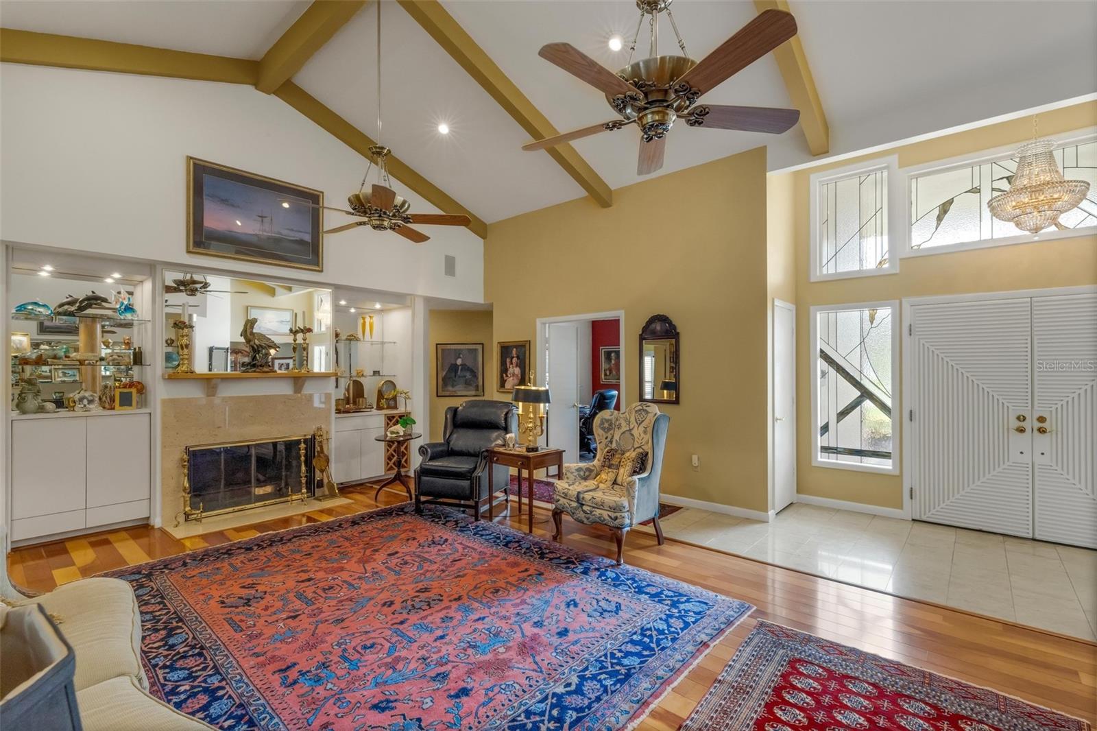 beamed ceilings, fireplace and custom built-ins at both ends of the room.