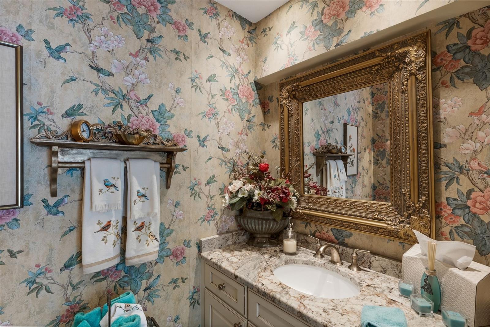 Around the corner is a bright and cheerful powder room for guest use.