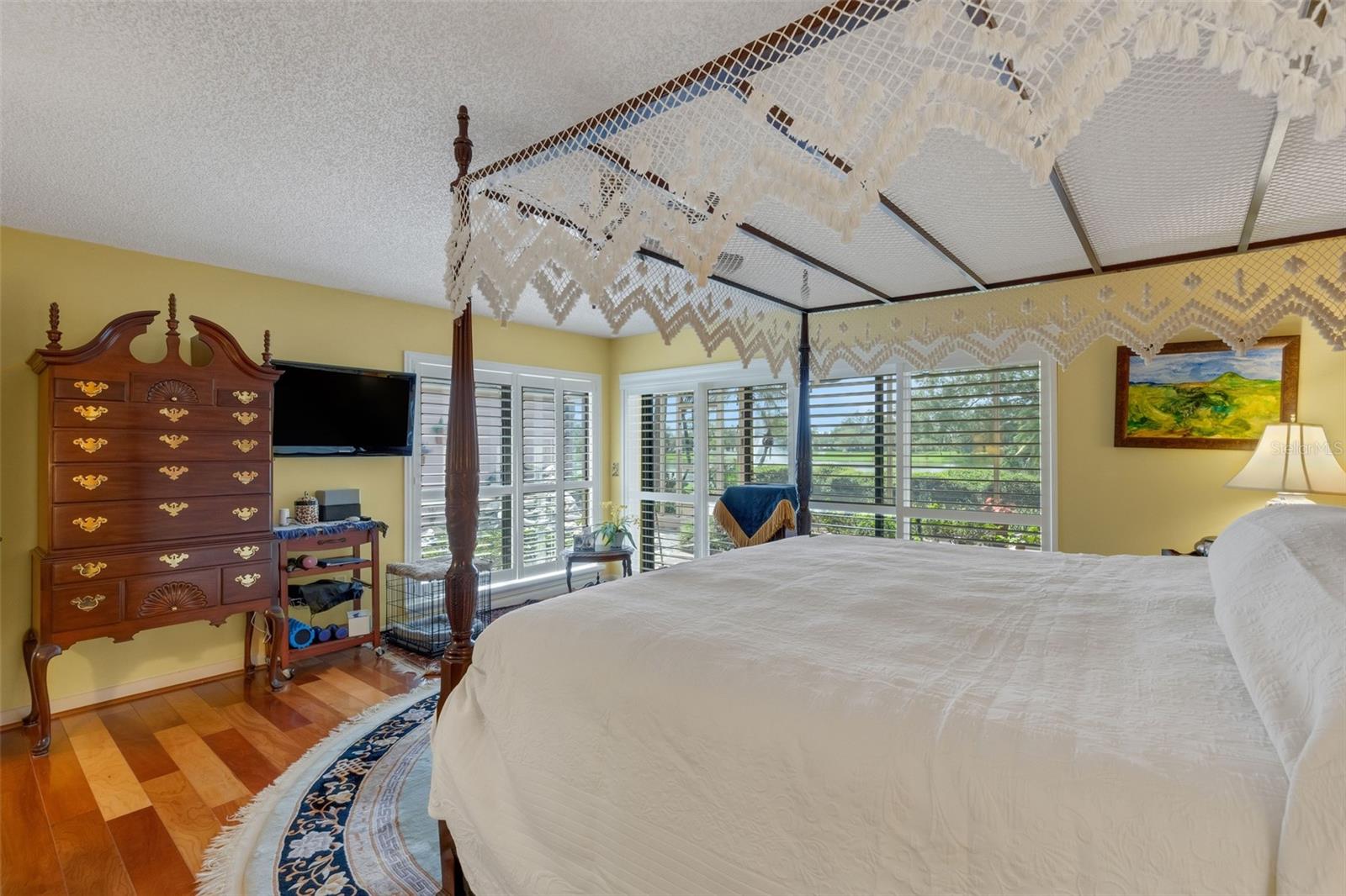 with two walls of windows to afford the occupant peaceful views of the rear courtyard, backyard and water beyond.