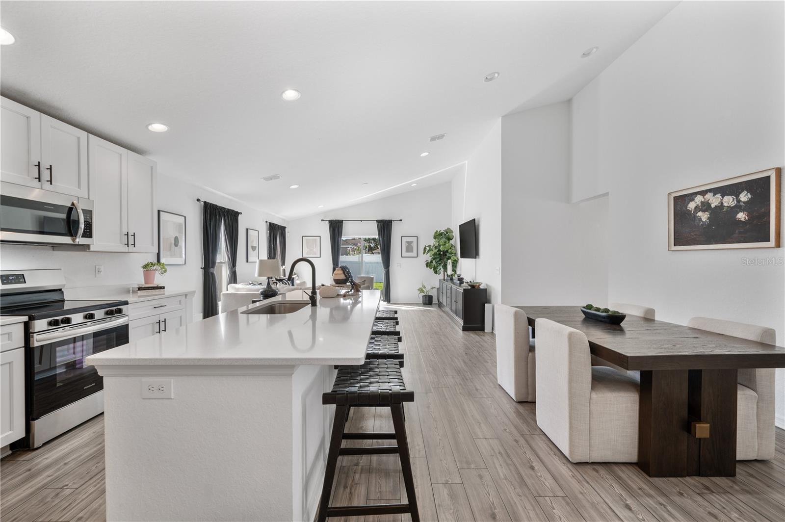 The kitchen & dining room are light & bright. Luxury vinyl plank flooring flow seamlessly throughout this entire home. The kitchen & dining room are light & bright. Luxury vinyl plank flooring flow seamlessly throughout this entire home.