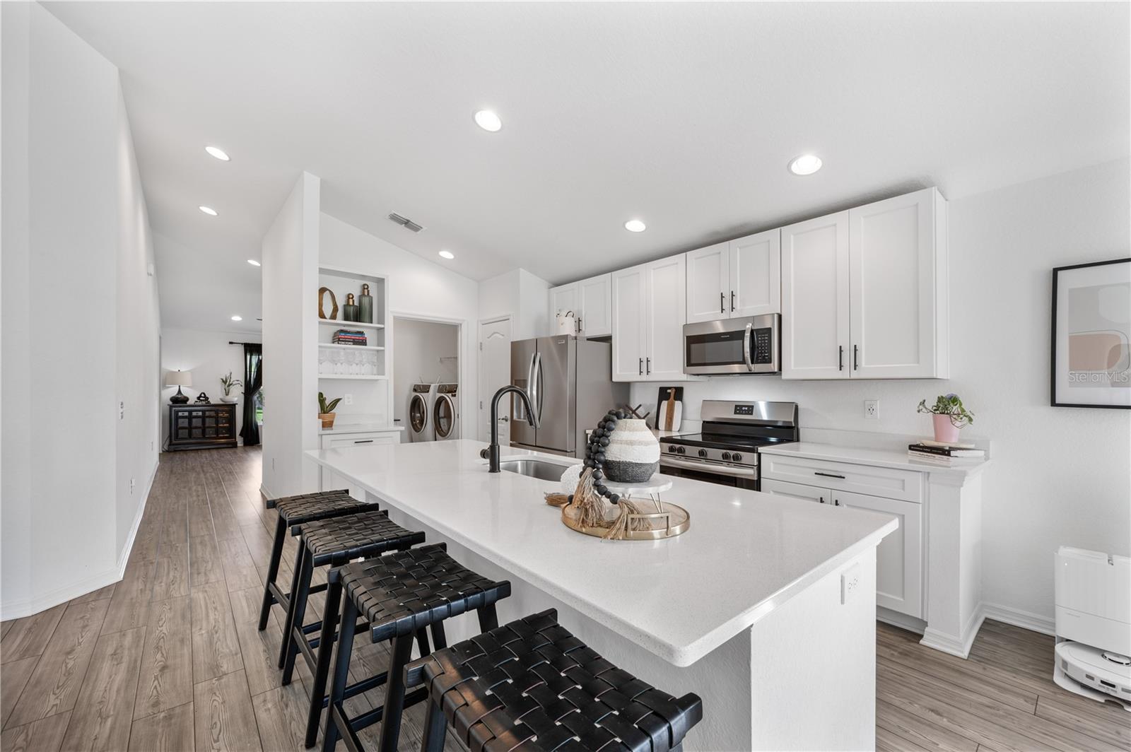 Quartz counters, stainless appliances, a huge center island with breakfast bar and plenty of storage