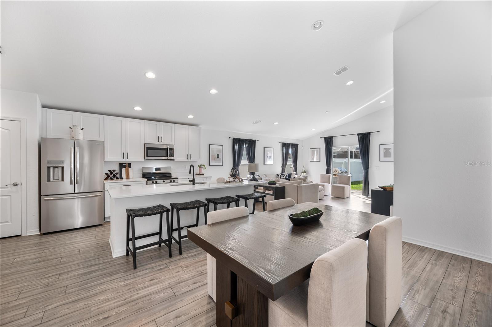 An expansive view form the dining room into the great room.