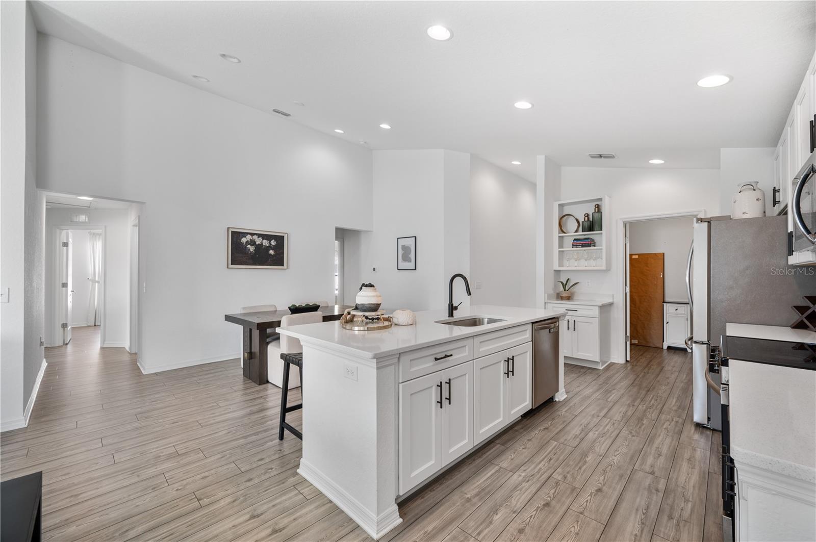 In the rear of this photo is a great Laundry room with plenty of storage
