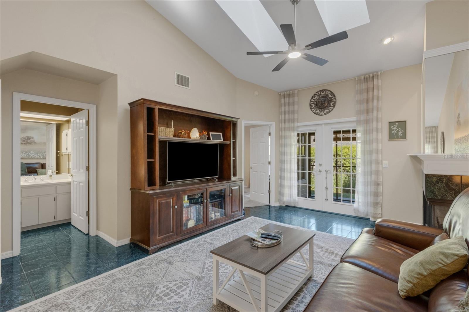 French doors lead to the covered screen enclosed lanai.