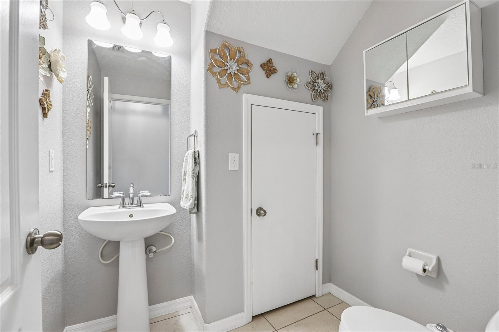 1/2 bath with storage and easy access to the water heater!