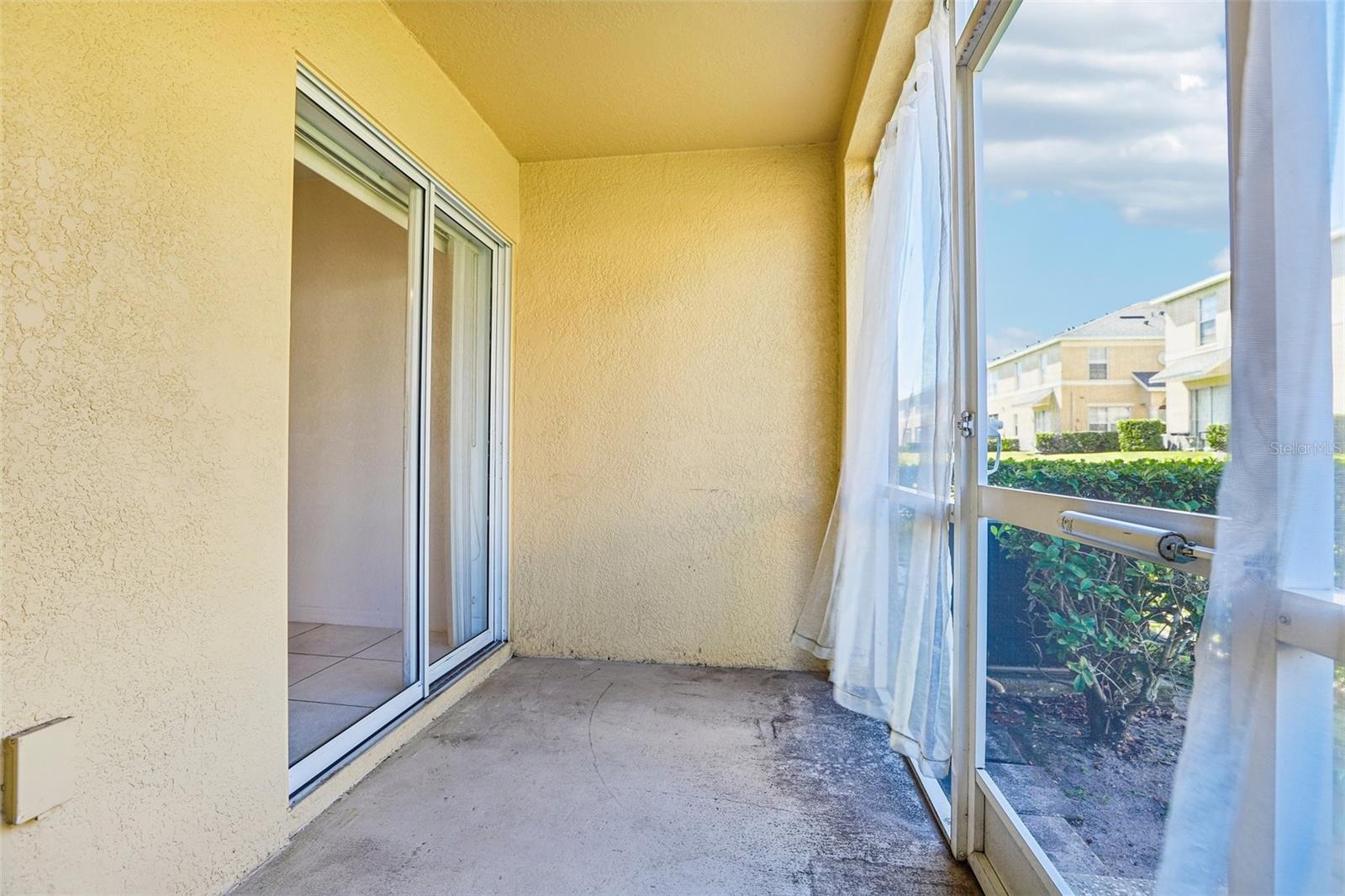 Large slider from the kitchen leads to the screened rear patio!