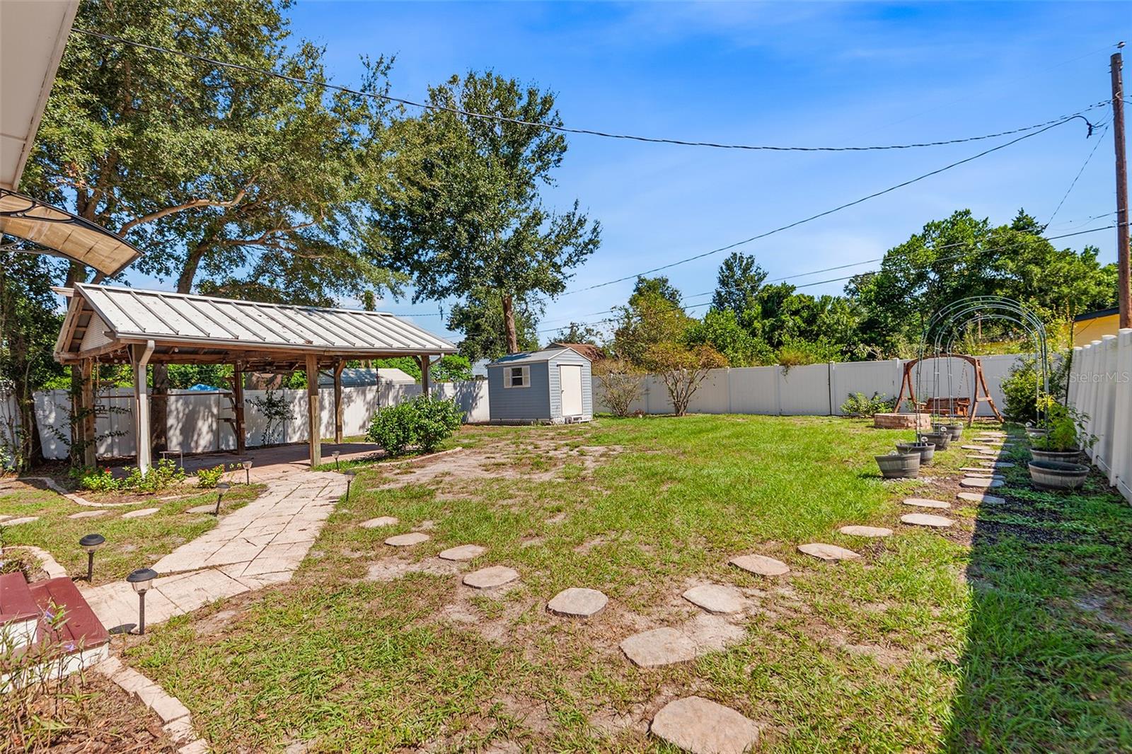 Firepit view with shed and stepping stones