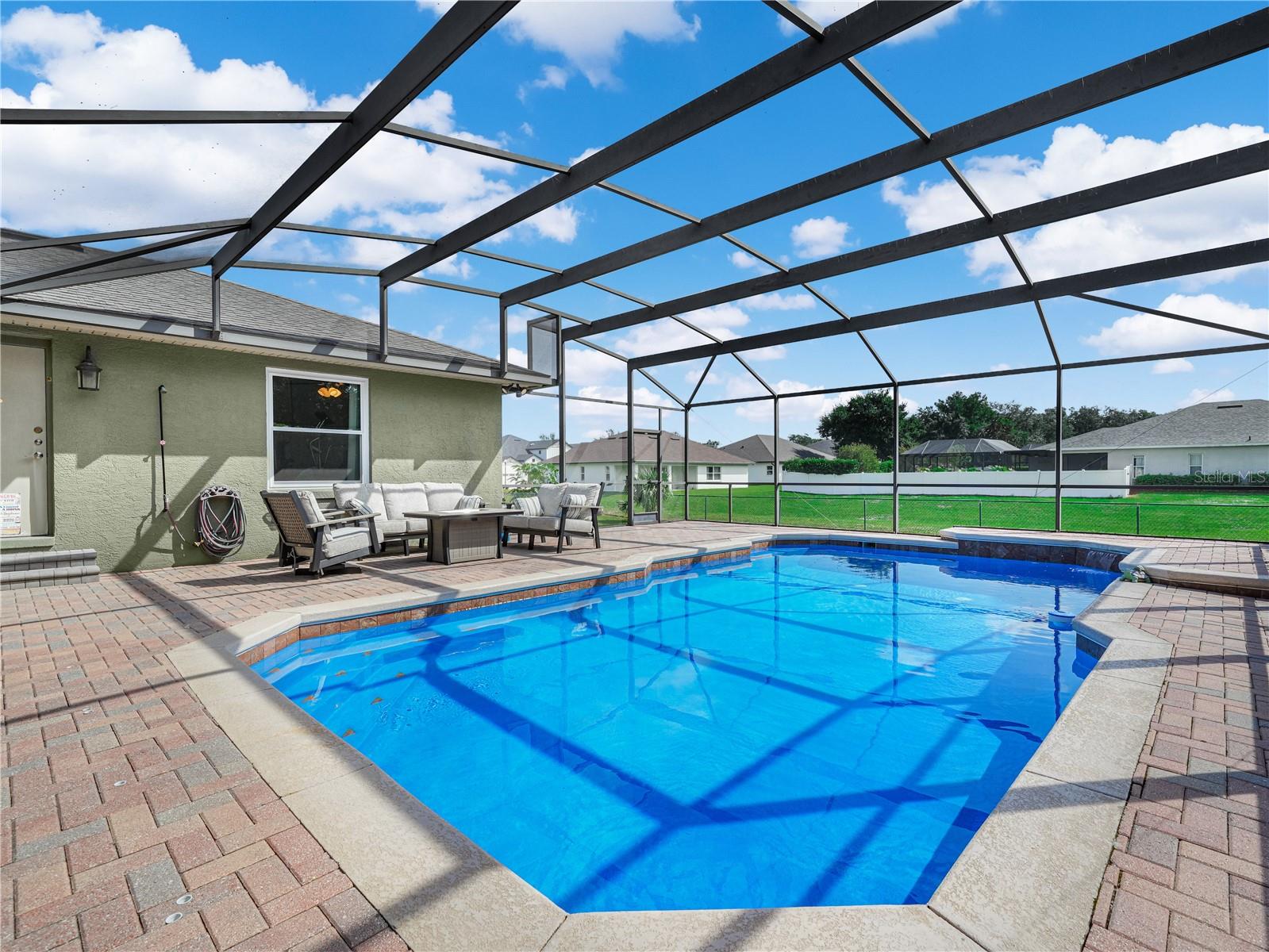 The pool with newer screen over looking the large back yard.