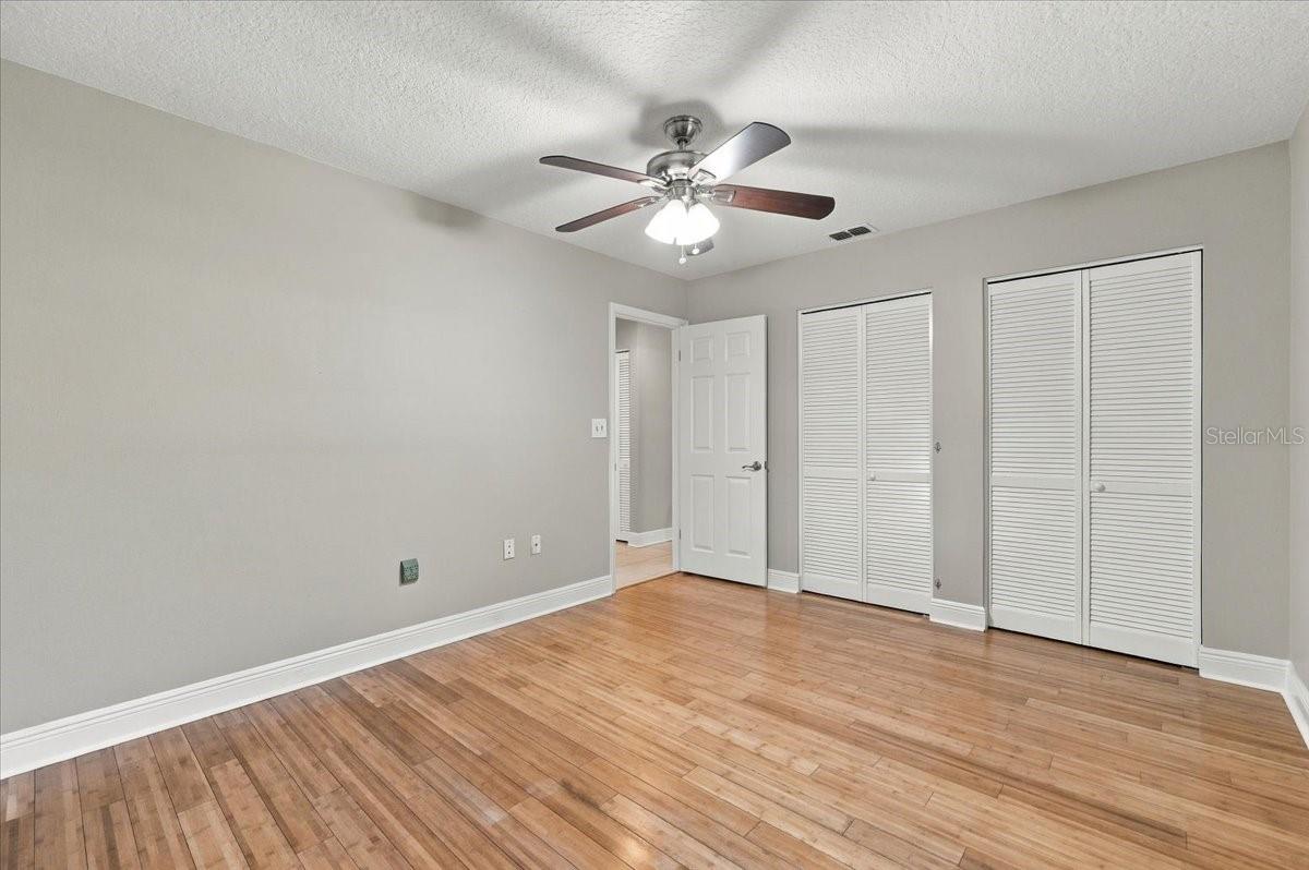 2nd bedroom with double closets, ceiling fan, new blinds and bamboo hardwood flooring.